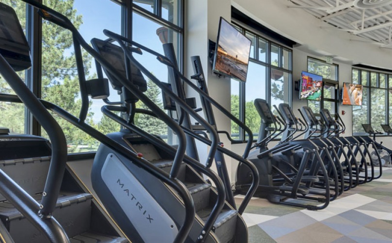 FItness center with a lot of cardio and weight machines, spacious.