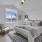 Bedroom with large bed, ensuite. queen bed and nightstands.