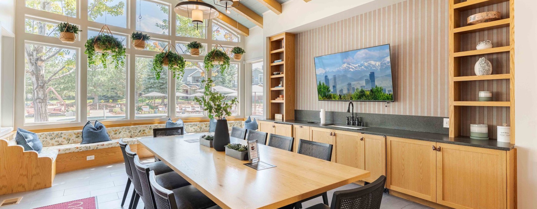 Conference room with couches and big table with TV